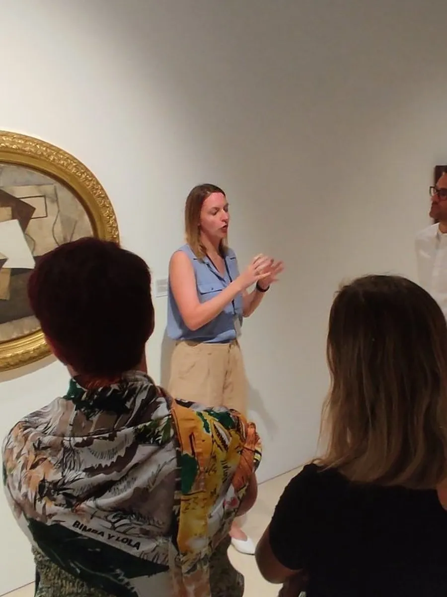 Anaïs Roossens talking to a small group in front of a Cubist still life.